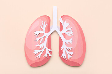 Pink paper lungs on beige background