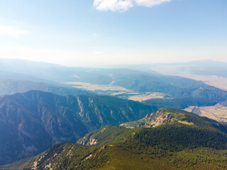 Fototapeta premium Rock formations with minimal vegetation. Nature in national park. Hiking. Aerial view mountain ranges surface blue water of mountain lakes, Bulgaria, Borovets, Musala peak summer