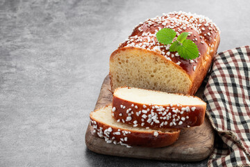 Sweet white loaf with sugar sprinkles on gray background