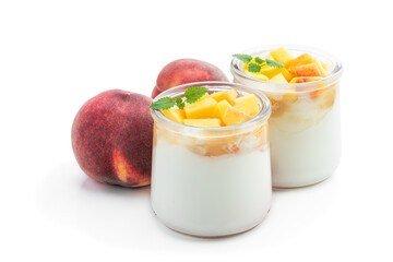 Homemade yogurt in a jar with fresh peach fruit isolated on white