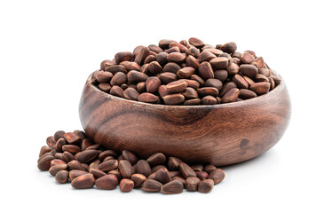 Pine nuts in wooden bowl isolated on white background