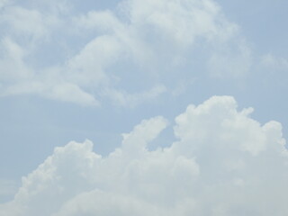 Puffy cumulus clouds forming within a blue sky over Kent County, Delaware.