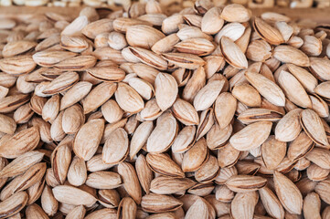 background with unpeeled almond kernels in a shell on a bazaar counter close up