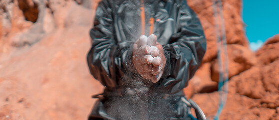Girl is climbing with magnesium powder on the rocks.