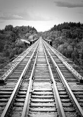 Obraz premium Black And White Of Desolate Railway Bridge Over The Saskatchewan River At Nipawin, Saskatchewan