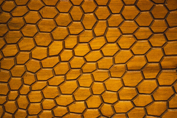 Abstract grunge wooden brown background with hexagonal. Honeycombs fractal seamless pattern texture. Golden surface of a wall. Decorative elements.