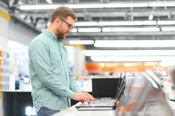 Client choosing laptop in store