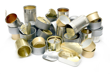 A set of empty food cans of different sizes and metal material on a white background.