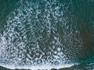 Waves on sea water with deep turquoise water, Aerial top down view