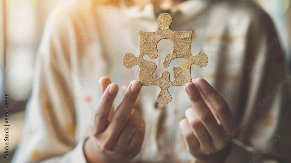 Poster a person holding a puzzle piece with a question mark on it symbolizing the difficulty in understandi
