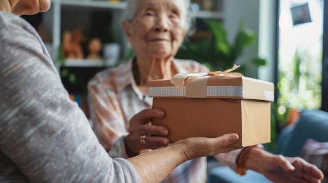 A volunteer delivering a personalized care package to an elderly individual in their home