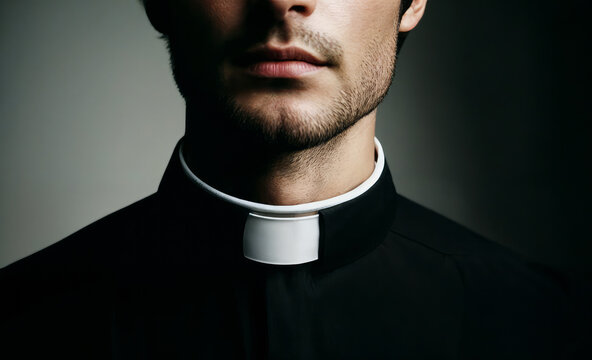 Close-up of a young male priest wearing a traditional clerical collar, emphasizing the religious attire.