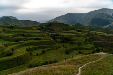 Chokhsky terraces Dagestan. Landscape of mountainous Dagestan with terraced fields and peaks mountains in the distance.