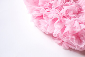 fluffy pink skirt with ruffles close-up. Elegant festive background. Sewing clothes with your own...
