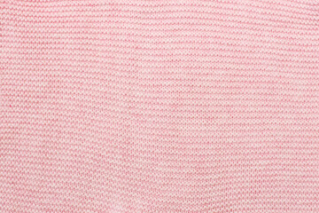 light pink garter stitch fabric knitted from wool close-up background.
