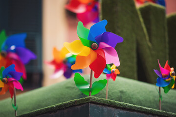 colored windmill on the roof. colorful windmills is waiting the arrival of the wind