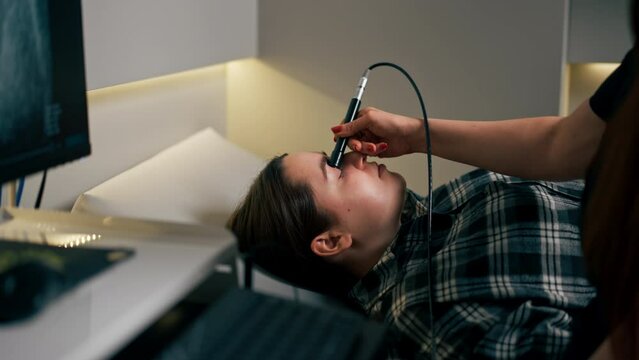 in an ophthalmology clinic young doctor performs an ultrasound of the eye of a young girl