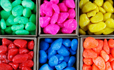 Top view of grouped boxes containing stones of different colors