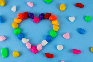 Heart formed with stones that have the colors of the rainbow