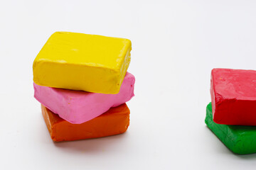 Colorful plasticine clay on white background.