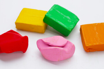 Colorful plasticine clay on white background.