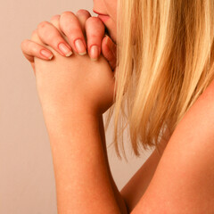 Woman holds hands to pray