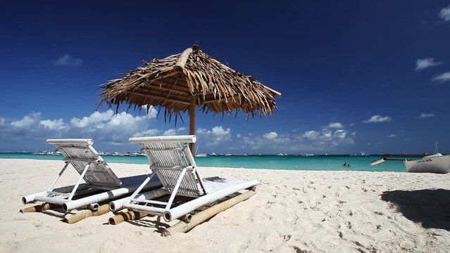 Sun umbrellas and beach chairs on tropical beach. Travel destination. Boracay
