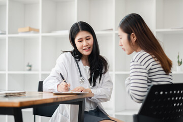 Female doctor consulting with a patient in a modern office setting, providing medical advice and...