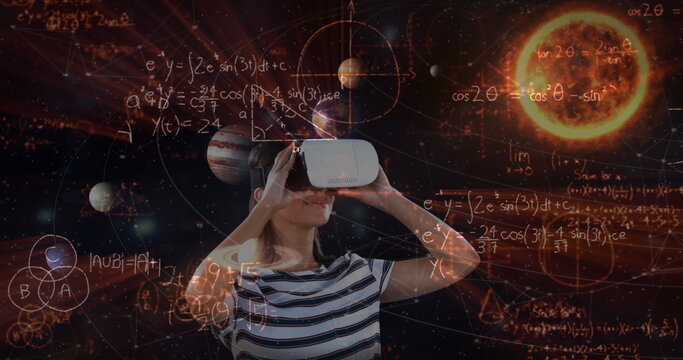Image of caucasian girl wearing virtual reality headset over planets background