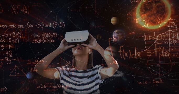 Image of caucasian girl wearing virtual reality headset over planets background