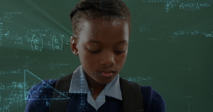 Image of african american school girl standing with chalkboard on background - Powered by Adobe