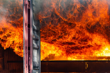 Fire flames engulfing from explosion and billowing inside burning premises. Blaze fire flames...