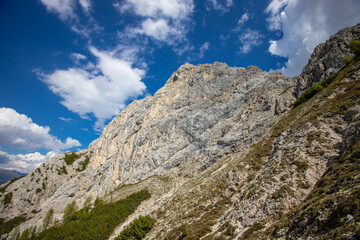 Dolomites mountains, Alpi Dolomiti beautiful scenic landscape in summer. Italian Alps mountain summits and rocky peaks above green valley alpine scene