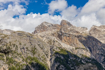 Dolomites mountains, Alpi Dolomiti beautiful scenic landscape in summer. Italian Alps mountain summits and rocky peaks above green valley alpine scene