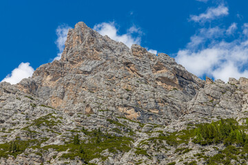 Dolomites mountains, Alpi Dolomiti beautiful scenic landscape in summer. Italian Alps mountain summits and rocky peaks above green valley alpine scene