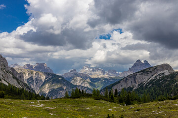 Dolomites mountains, Alpi Dolomiti beautiful scenic landscape in summer. Italian Alps mountain summits and rocky peaks above green valley alpine scene