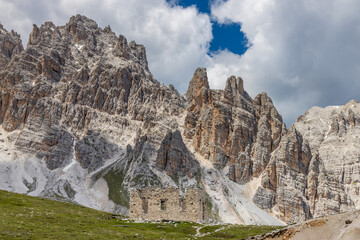Dolomites mountains, Alpi Dolomiti beautiful scenic landscape in summer. Italian Alps mountain summits and rocky peaks above green valley alpine scene