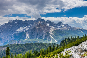 Dolomites mountains, Alpi Dolomiti beautiful scenic landscape in summer. Italian Alps mountain summits and rocky peaks above green valley alpine scene