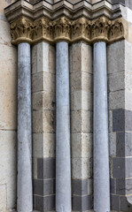 decorative columns on the wall of an old stone castle in Europe
