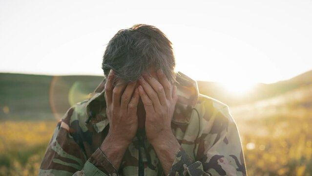 Soldier cover his face with palms