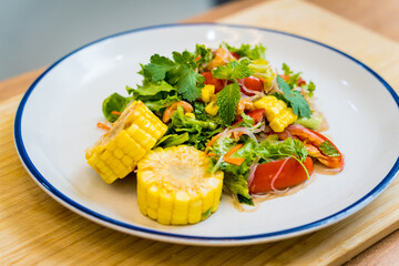 Spicy glass noodle salad on the white plate