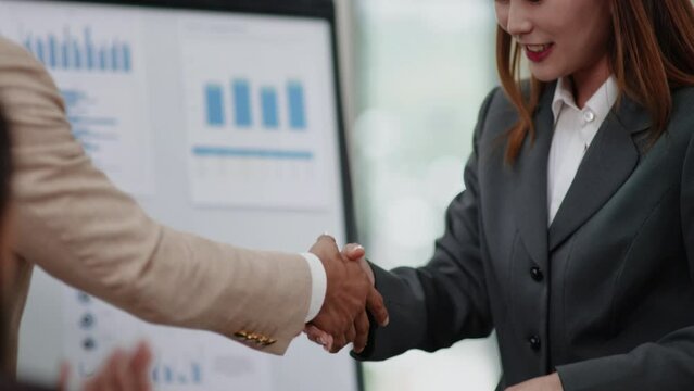 Group of teamwork businesspeople are clapping hands and shakehands after presentation success and archive dealing business agreement on business financial and marketing in office