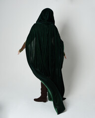 Full length portrait of red haired female model, wearing green medieval fantasy costume, long...