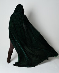 Full length portrait of red haired female model, wearing green medieval fantasy costume, long...