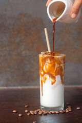 ice caramel macchiato coffee on  rustic table background.