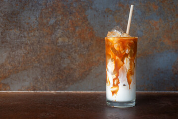 ice caramel macchiato coffee on  rustic table background.