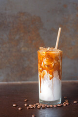 ice caramel macchiato coffee on  rustic table background.