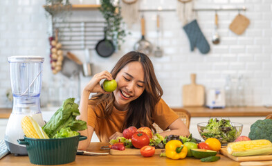 Portrait of beauty body slim healthy asian woman big smile cooking and preparing vegan food healthy holding apple, green apple, dental, teeth, fruit in kitchen at home.Diet.Fitness, healthy food
