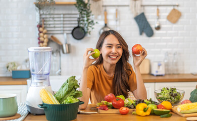 Portrait of beauty body slim healthy asian woman big smile cooking and preparing vegan food healthy holding apple, green apple, dental, teeth, fruit in kitchen at home.Diet.Fitness, healthy food