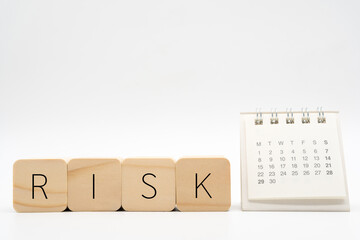 Risk word on wooden block with calendar. Financial Crisis, Economic, Business risk management...